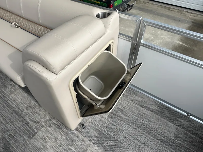 Slide: The Image of 2024 Ranger Reata 220C pontoon boat interior with plush seating and steering console. - 11