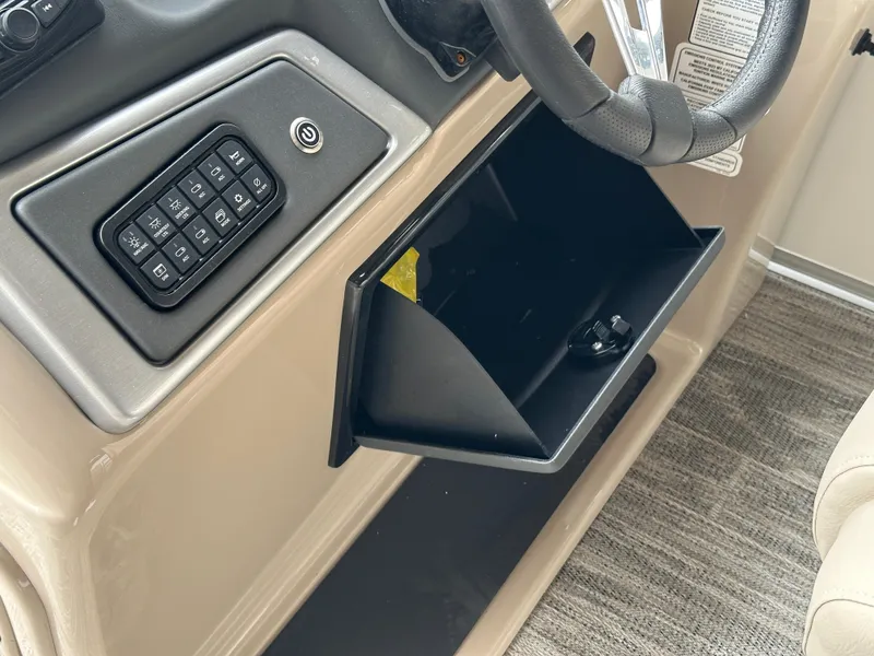 Slide: The Image of 2024 Ranger Reata 220C boat seat with storage compartment, featuring beige quilted upholstery. - 14