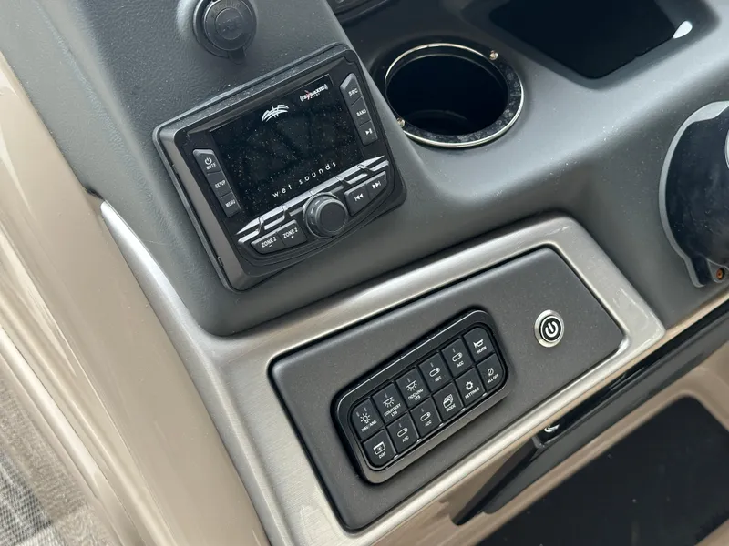 Slide: The Image of 2024 Ranger Reata 220C boat interior with beige seating and gray flooring. - 15