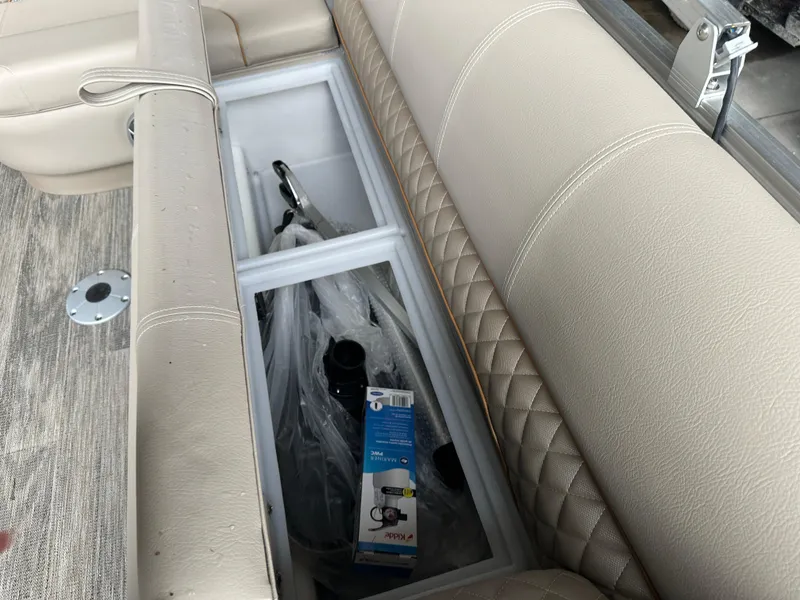 Slide: The Image of 2024 Ranger Reata 220C boat interior with storage compartment and cup holder. - 16