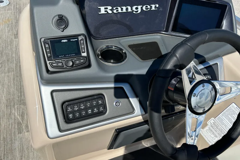Slide: The Image of 2024 Ranger Reata 220C boat dashboard with steering wheel and control panel. - 22