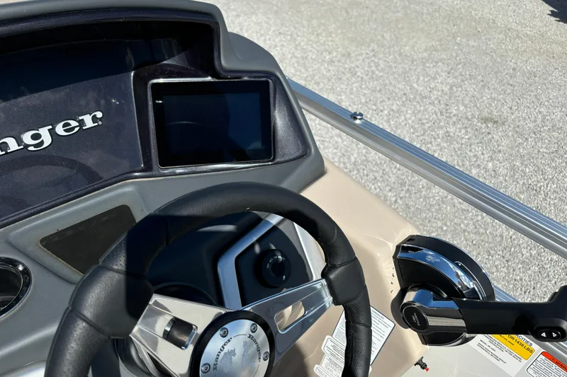 Slide: The Image of 2024 Ranger Reata 220C boat dashboard with steering wheel and control panel. - 23
