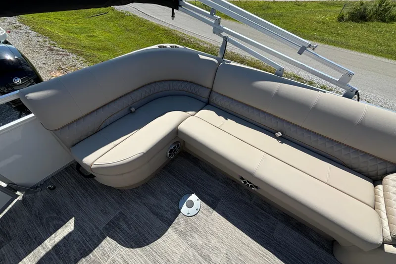 Slide: The Image of 2024 Ranger Reata 220C boat interior with beige seating and modern design. - 24