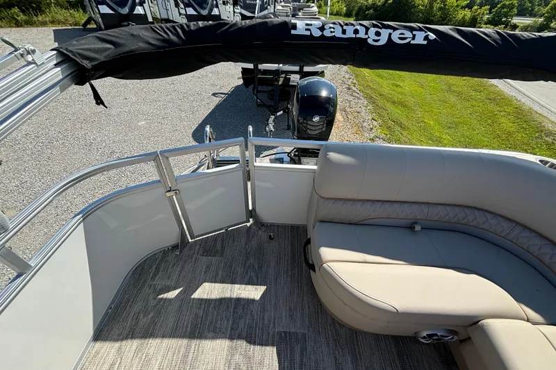 Slide: The Image of 2024 Ranger Reata 220C pontoon boat interior with seating and railing. - 25