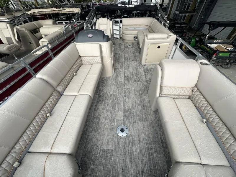 Slide: The Image of 2024 Ranger Reata 220C boat interior with beige seating and storage compartments. - 7