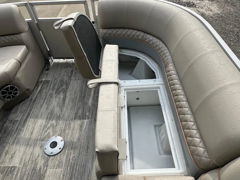 Slide: The Image of 2024 Ranger Reata 220C boat seat with built-in storage compartment and trash bin. - 9