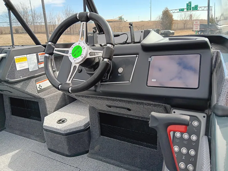 Slide: The Image of 2024 Ranger VX1988 WT boat dashboard with steering wheel and control panel. - 5