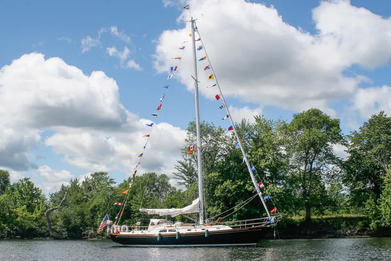 Slide: The Image of 1996 Hinckley Sou'wester 42 MKII sailboat on calm water, scenic background. - 1