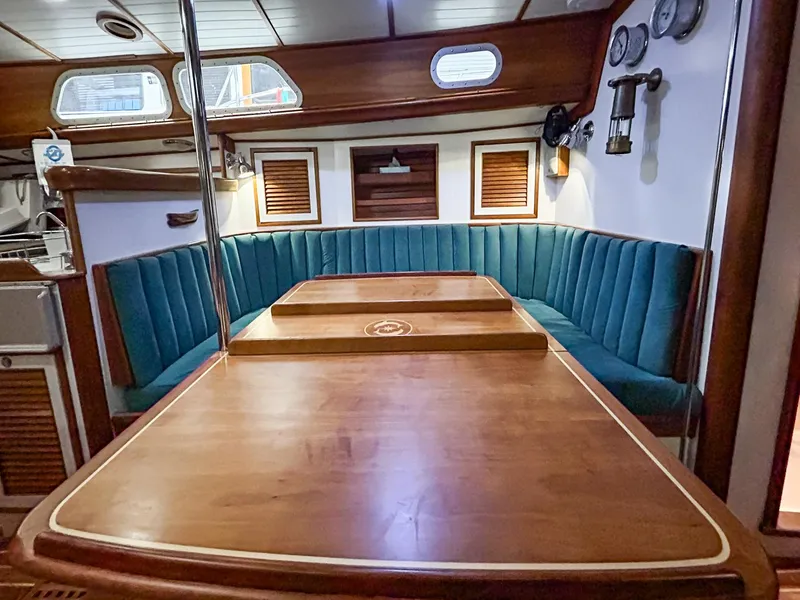 Slide: The Image of Interior of 1996 Hinckley Sou'wester 42 MKII yacht with green cushioned seating. - 27
