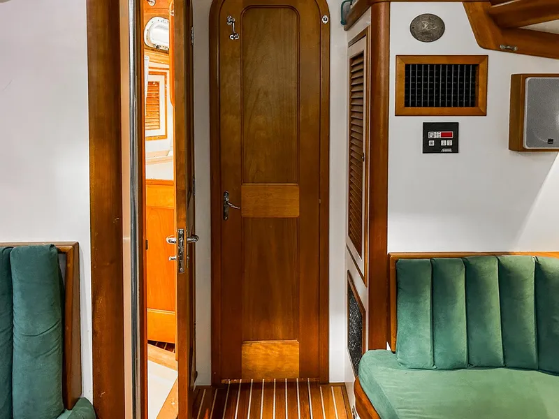 Slide: The Image of Interior of 1996 Hinckley Sou'wester 42 MKII sailboat with wooden table and teal seating. - 31