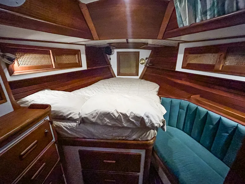 Slide: The Image of Cabin interior of 1996 Hinckley Sou'wester 42 MKII with green bedding and wooden furnishings. - 32