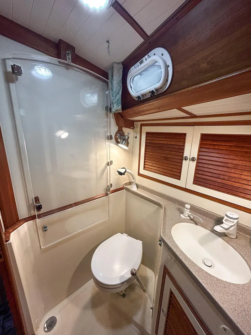 Slide: The Image of 1996 Hinckley Sou'wester 42 MKII cabin with cozy bed and teal seating. - 36