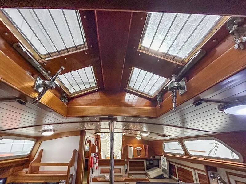 Slide: The Image of Cozy cabin interior of 1996 Hinckley Sou'wester 42 MKII with wooden accents and bedding. - 37