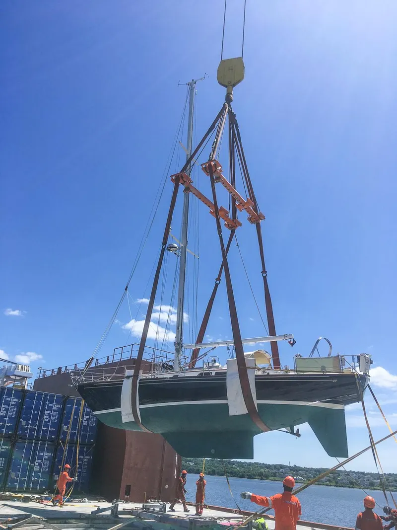 Slide: The Image of Sailboat Hinckley Sou'wester 42 MKII 1996 on a scenic lake with colorful flags. - 5