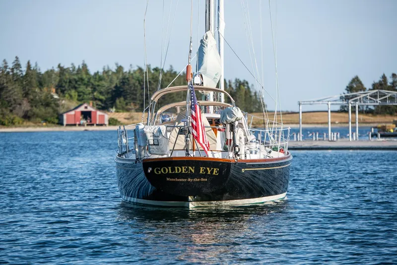 Slide: The Image of Hinckley Sou'wester 42 MKII sailboat, 1996, named "Golden Eye" on calm water. - 60