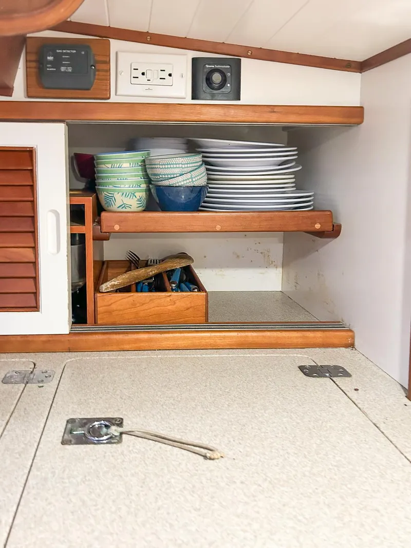 Slide: The Image of 1996 Hinckley Sou'wester 42 MKII yacht kitchen with stove, sink, and wooden cabinetry. - 19