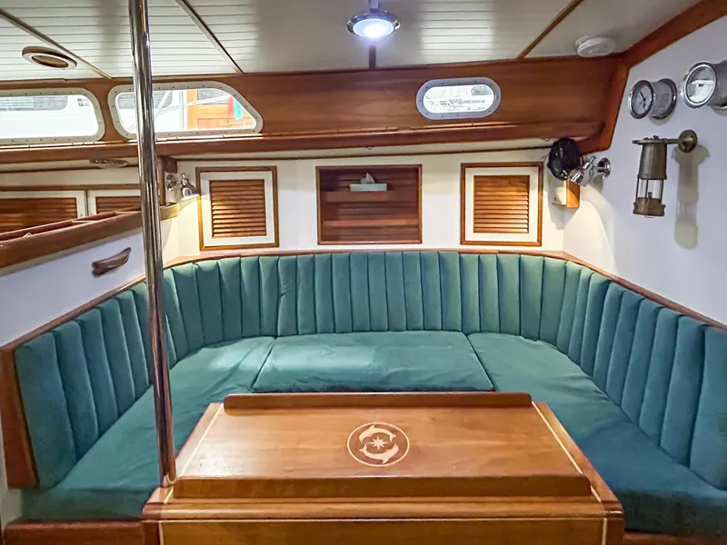 Slide: The Image of Interior of 1996 Hinckley Sou'wester 42 MKII sailboat with wood paneling and seating area. - 25