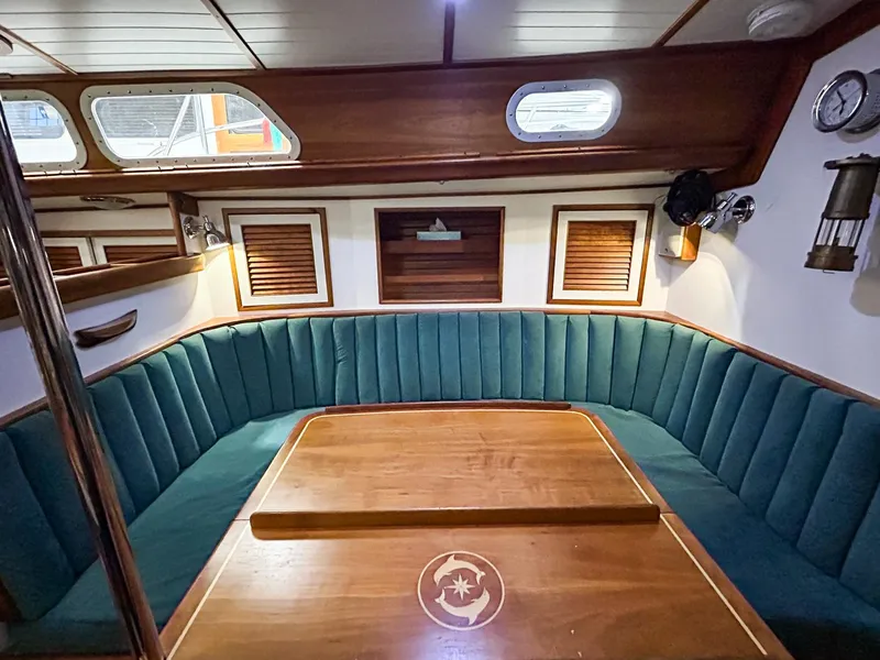 Slide: The Image of Interior of 1996 Hinckley Sou'wester 42 MKII sailboat with wood paneling and green seating. - 26