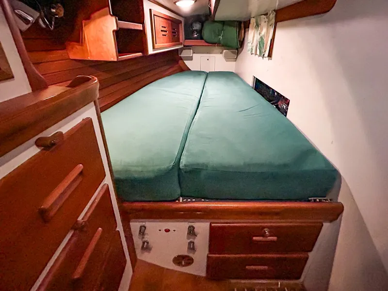 Slide: The Image of Interior of 1996 Hinckley Sou'wester 42 MKII yacht with teal seating and wooden accents. - 29