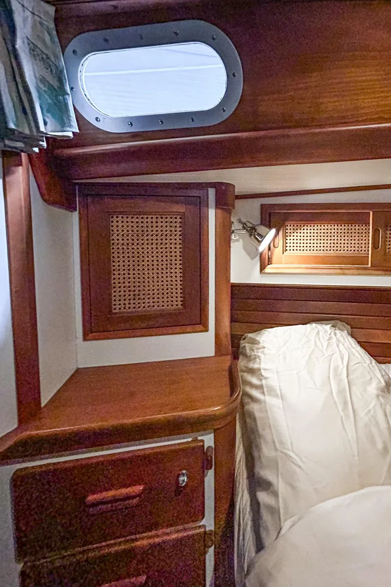 Slide: The Image of Interior of 1996 Hinckley Sou'wester 42 MKII yacht with wooden door and green seating. - 35