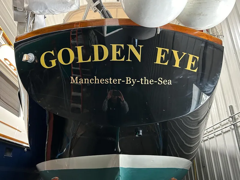 Slide: The Image of Hinckley Sou'wester 42 MKII sailboat, 1996 model, in storage with a sleek black and turquoise hull. - 44