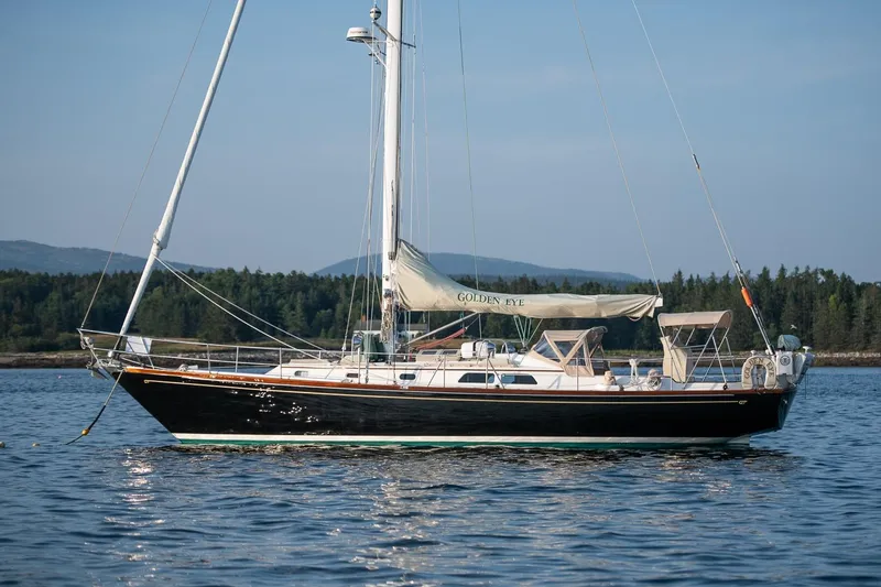 Slide: The Image of Sailing yacht Hinckley Sou'wester 42 MKII, 1996, on calm water with forested background. - 57