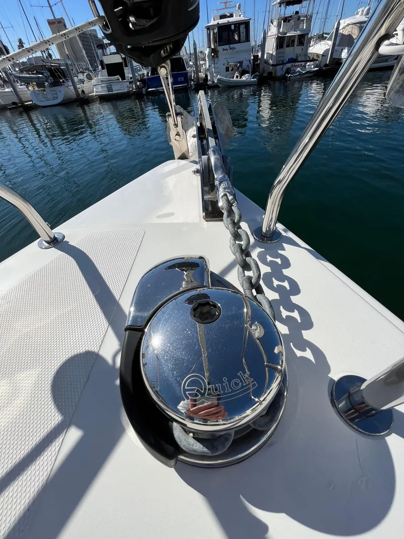 Slide: The Image of Anchor chain and windlass on a 2021 Bavaria C45 yacht in a marina. - 13