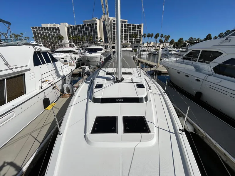Slide: The Image of Bavaria C45 2021 sailboat docked in a marina with other yachts. - 14