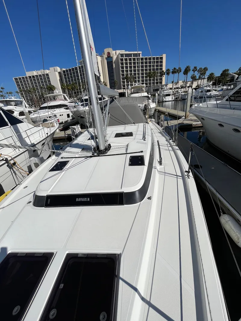 Slide: The Image of 2021 Bavaria C45 sailboat docked at a marina with other yachts. - 15