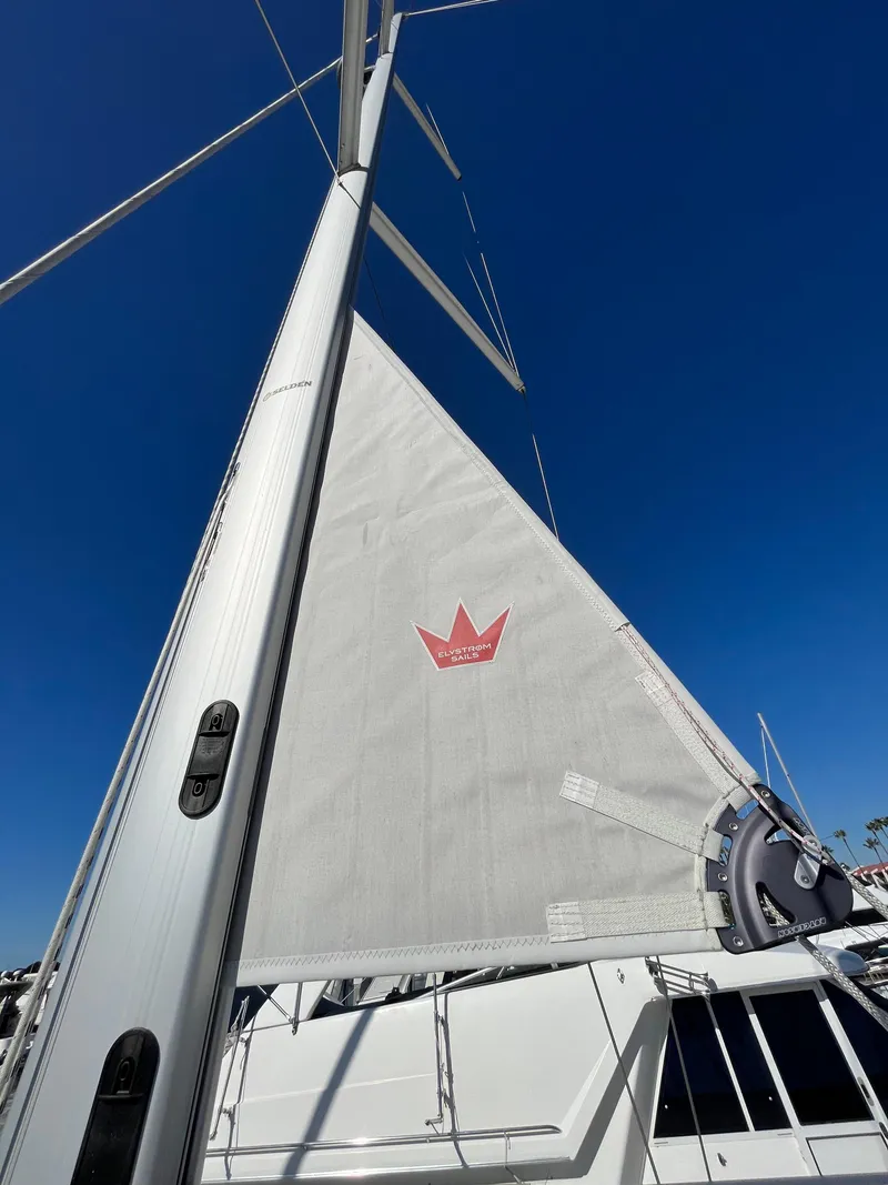 Slide: The Image of 2021 Bavaria C45 sailboat with white sail against a clear blue sky. - 16