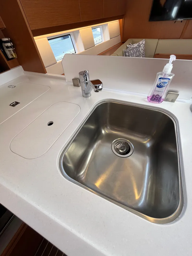 Slide: The Image of Modern kitchen sink in 2021 Bavaria C45 yacht with white countertop. - 35