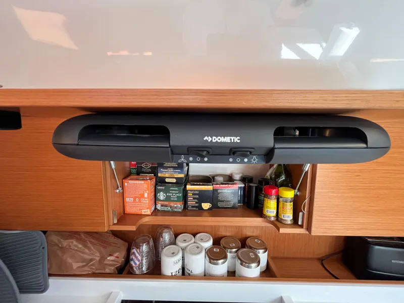 Slide: The Image of Bavaria C45 2021 yacht kitchen with Dometic appliance and organized spices. - 42