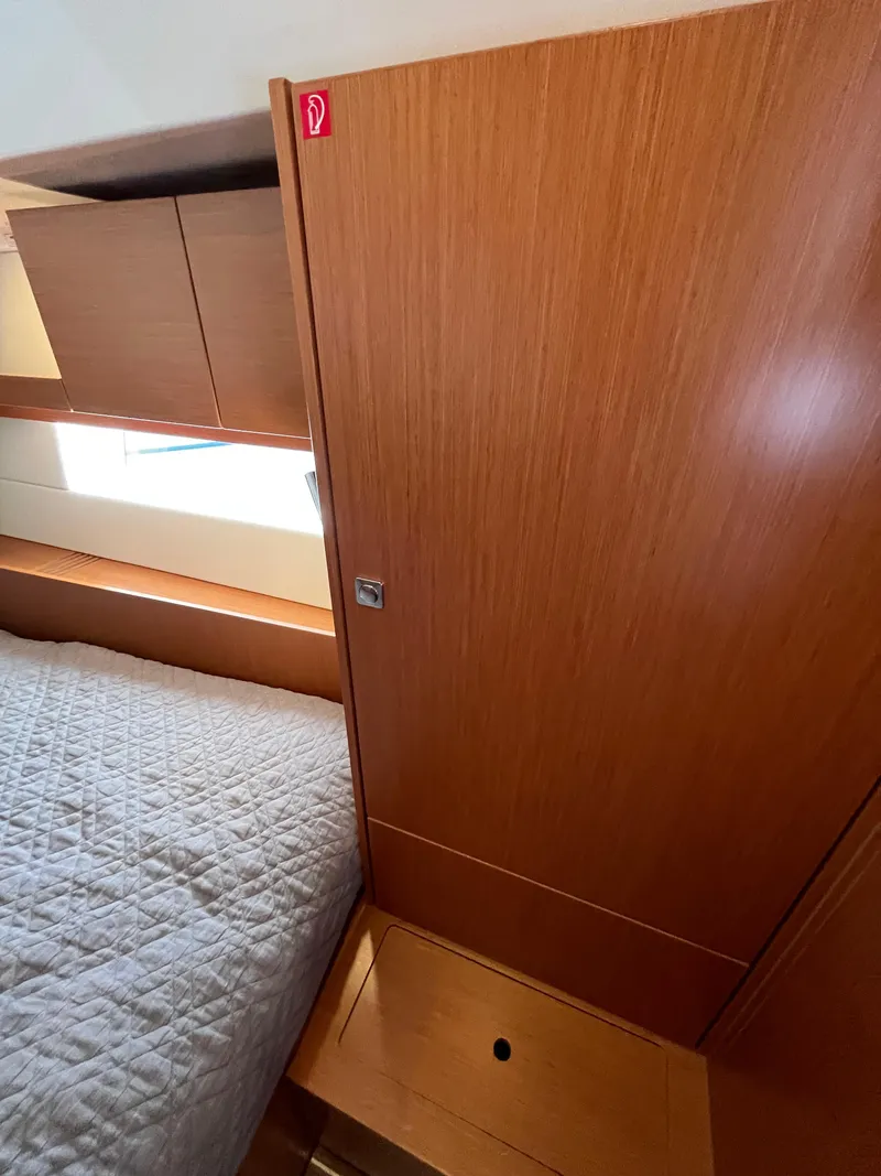 Slide: The Image of Interior cabin of 2021 Bavaria C45 yacht with wooden finish and bed. - 46