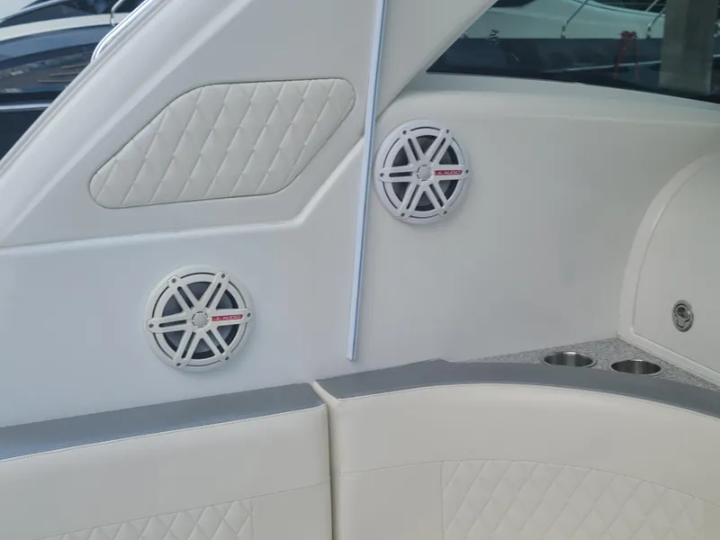 Slide: The Image of Interior of a 2007 Formula 45 Yacht with white leather seating and built-in speakers. - 19