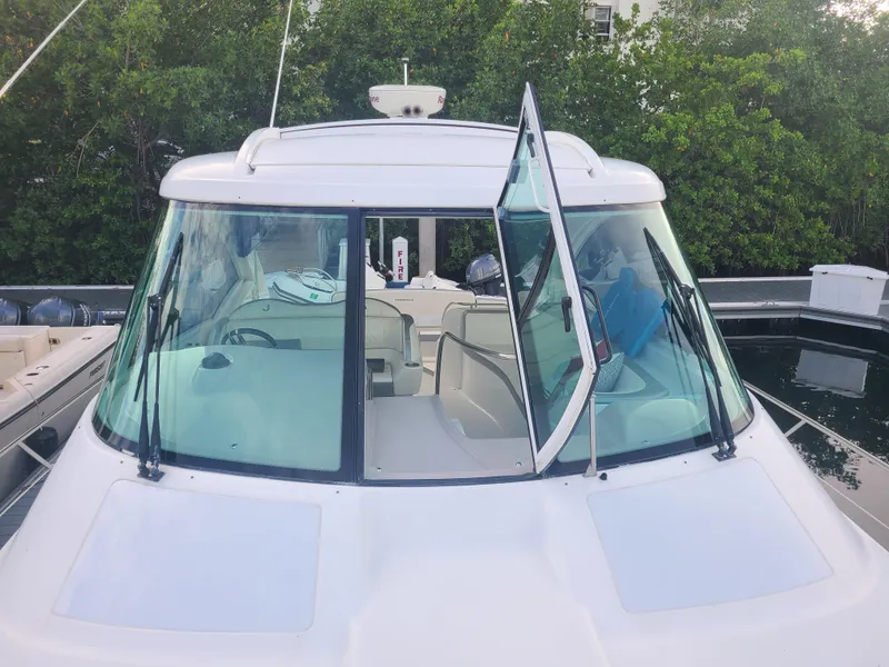 Slide: The Image of 2007 Formula 45 Yacht with open windshield, docked near greenery. - 2