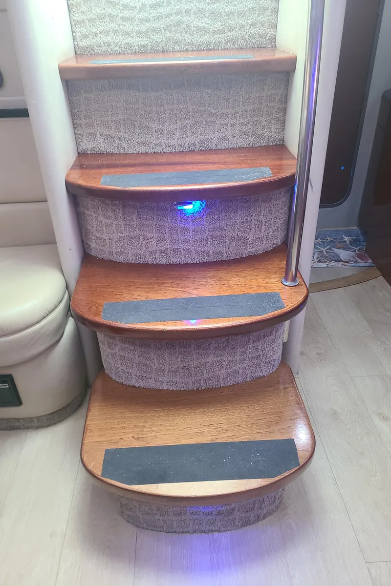 Slide: The Image of Staircase inside 2007 Formula 45 Yacht with wooden steps and blue LED lighting. - 22