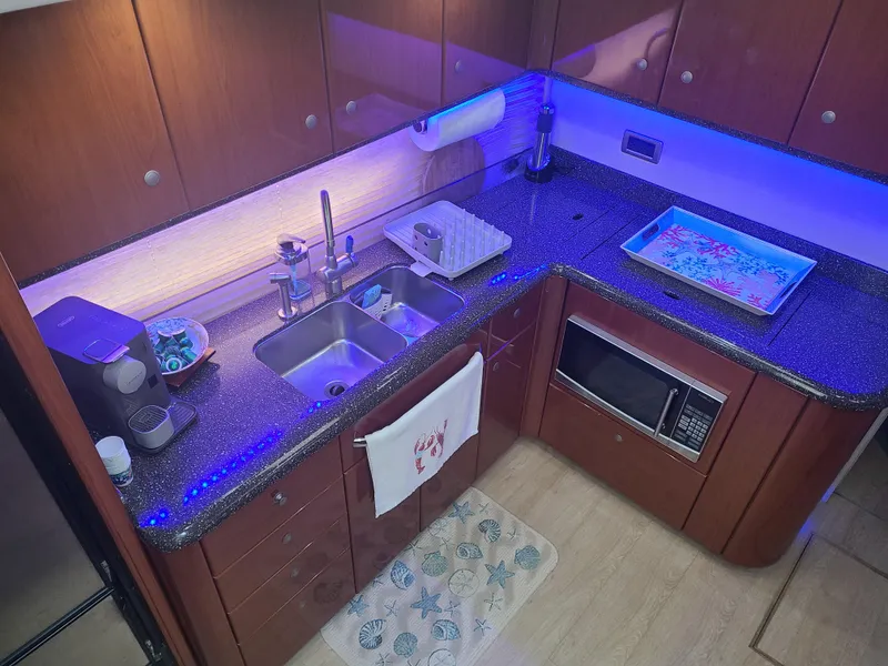 Slide: The Image of 2007 Formula 45 Yacht kitchen with modern appliances and blue LED lighting. - 23