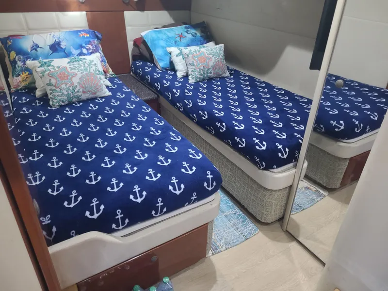 Slide: The Image of Twin beds with nautical-themed bedding in a 2007 Formula 45 Yacht cabin. - 35