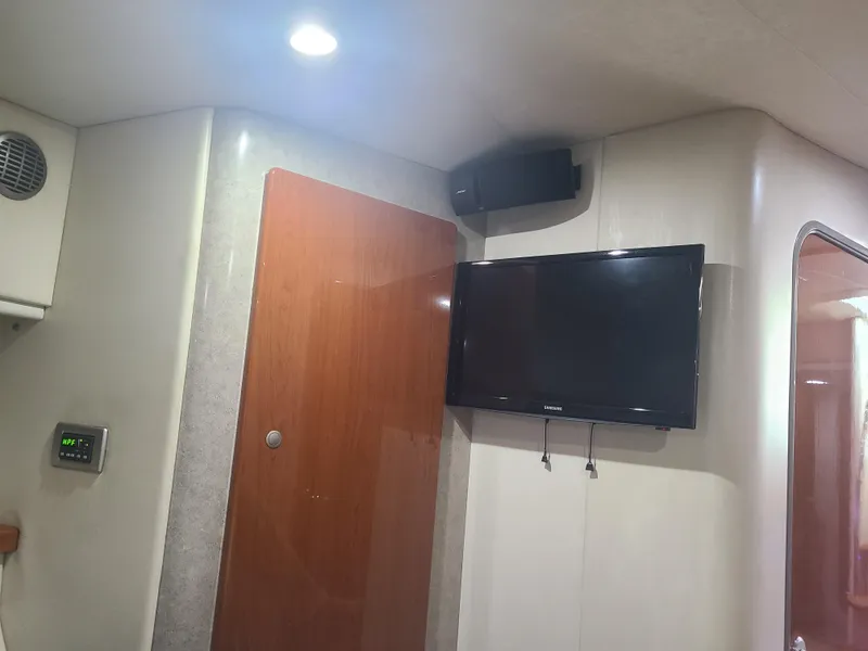 Slide: The Image of Interior of a 2007 Formula 45 Yacht with mounted TV and wooden door. - 37