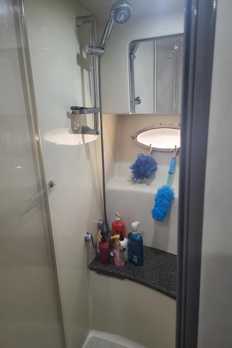 Slide: The Image of 2007 Formula 45 Yacht bathroom with shower, toiletries, and cleaning supplies. - 39
