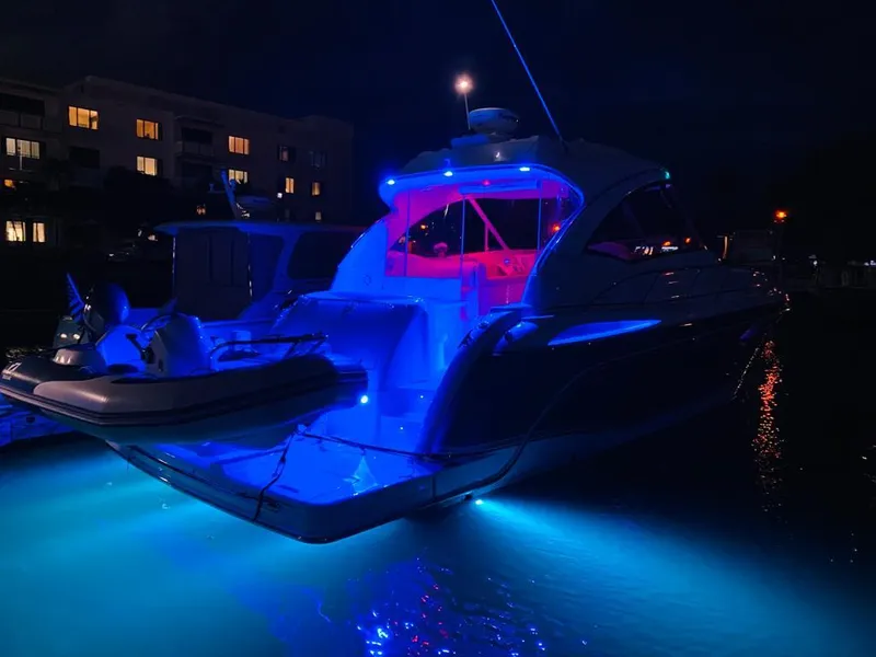 Slide: The Image of 2007 Formula 45 Yacht illuminated with blue and red lights at night. - 40