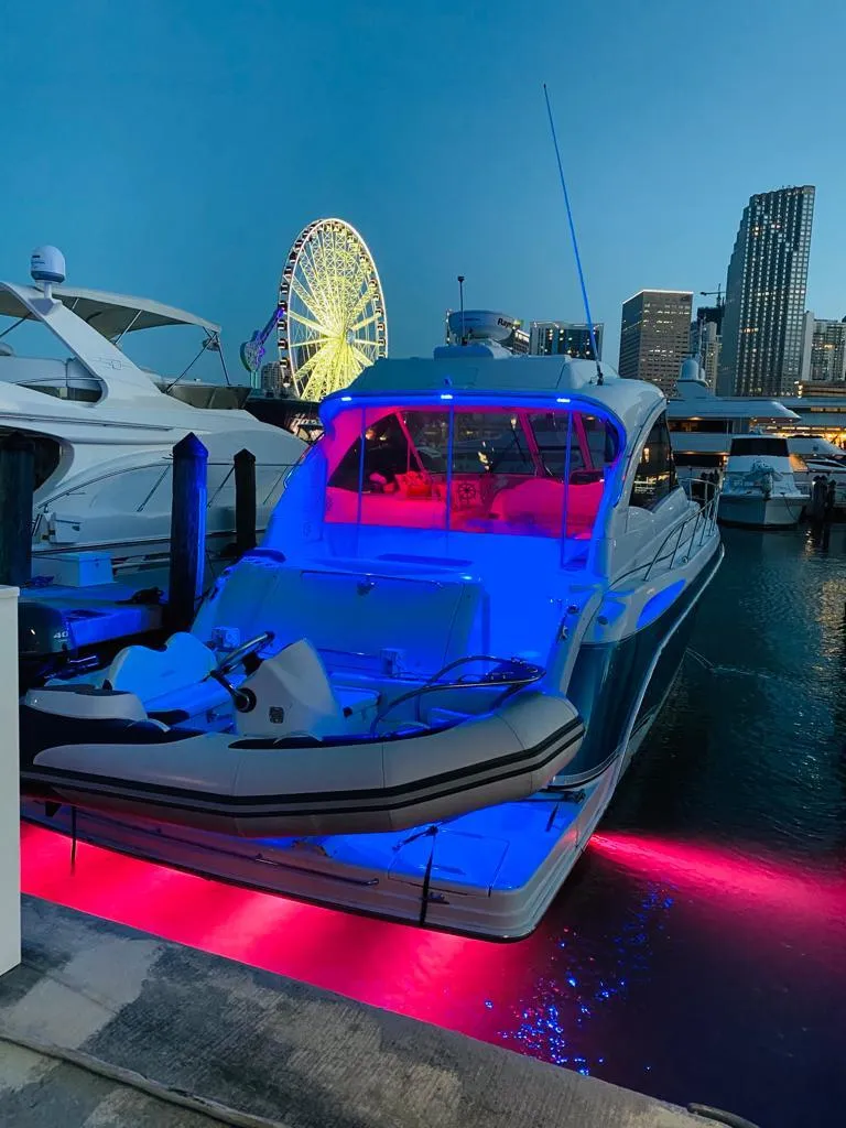 Slide: The Image of 2007 Formula 45 Yacht docked at night with vibrant blue and pink lights. - 41