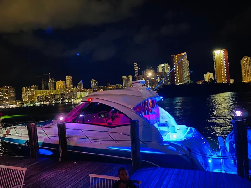 Slide: The Image of 2007 Formula 45 Yacht docked at night with city skyline in the background. - 42