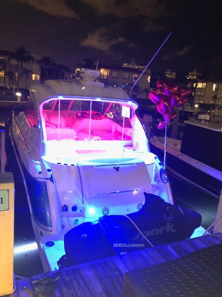 Slide: The Image of 2007 Formula 45 Yacht docked at night with vibrant LED lighting. - 45