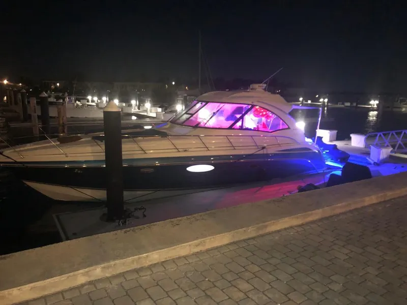 Slide: The Image of 2007 Formula 45 Yacht docked at night with vibrant interior lighting. - 46