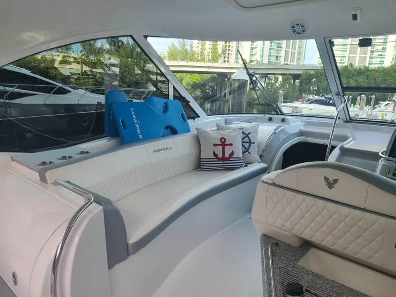 Slide: The Image of Interior of a 2007 Formula 45 Yacht with white seating and nautical decor. - 7