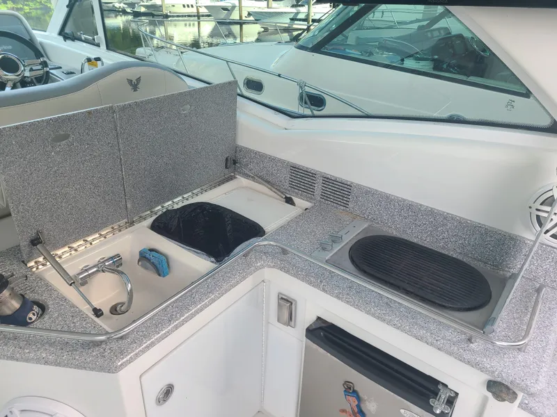 Slide: The Image of 2007 Formula 45 Yacht interior kitchen area with sink, stove, and mini-fridge. - 9