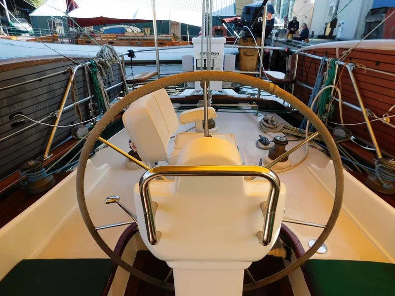 Slide: The Image of Helm of 1964 Custom 65 Pilothouse Schooner with wooden accents and nautical equipment. - 11