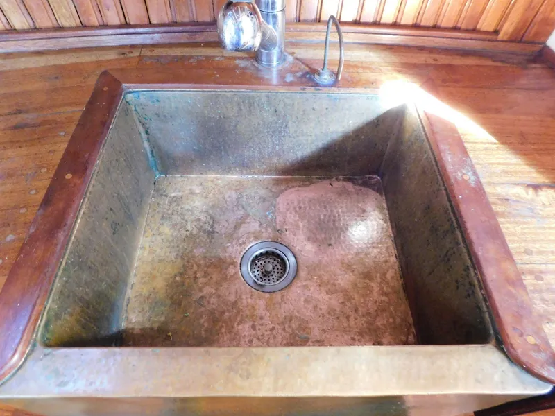 Slide: The Image of Rustic metal sink on a 1964 Custom 65 Pilothouse Schooner with wooden countertop. - 3