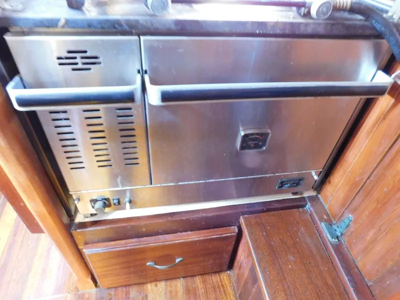 Slide: The Image of Stainless steel oven in 1964 Custom 65 Pilothouse Schooner's wooden interior. - 4